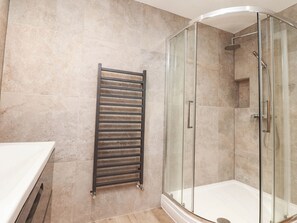 A modern bathroom with a glass-enclosed shower, a towel rack, and a white countertop. - 4 Church Hall Mews (Preston)