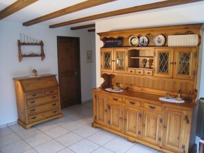 A room with a wooden cabinet with multiple drawers and a shelf, a wooden door, and a tiled floor. - Casa Laghetto 5 Appartement/Fewo, Bad, WC, 4-Bettwohnung 4-Bettwohnung by Interhome (Arosa)