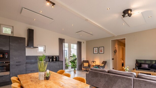 A modern living space with a dining area, kitchen, and seating area. - Vakantiepark Aan de Maas - Weide Lande | 6p by Interhome (Kerkdriel)