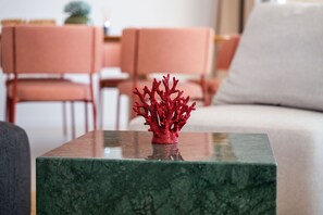 A red coral sculpture on a marble table in a living room with a sofa and chairs. - Villa Salis with heated pool & sea view (Košljun)