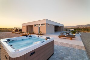 A modern spa facility with a hot tub, outdoor seating, and a view of the surrounding landscape. - Villa Salis with heated pool & sea view (Košljun)