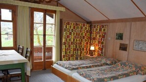 A room with two beds, a table, chairs, a lamp, and curtains. - Chalet Maru Appartement/Fewo, Dusche oder Bad, WC, 3 Schlafräume 7-Bett-Wohnung by Interhome (Lenk)