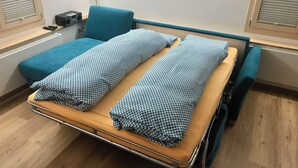 A hospital room with a bed, a small bedside table, a radio, and a window with blinds. - Lischenhaus 2 - Wohnung Flösch Appartement/Fewo, Dusche, WC, 1 Schlafraum by Interhome (Lenk)