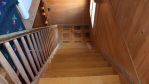 A wooden staircase with a handrail, leading to a room with a patterned carpet. - Steirösli 1. & 2. Stock Appartement/Fewo, Dusche und Badewanne, 4 oder mehr Schl by Interhome (Lenk)