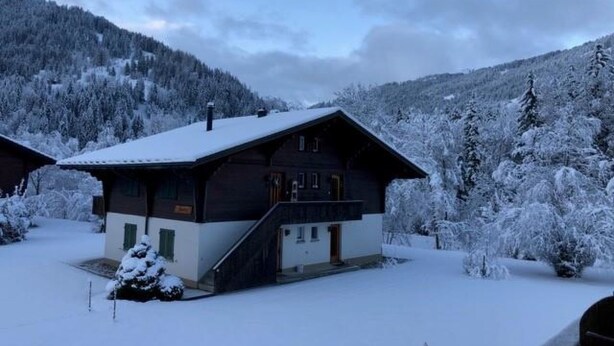 A two-story cabin with a steep roof, surrounded by snow-covered trees and hills. - Reseda Appartement/Fewo, Dusche und Bad, WC, 2 Schlafräume 4-Bettwohnung by Interhome (Lenk)