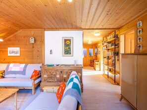 A cozy room with a sofa, a wooden cabinet, and a bookshelf. - Berna 2. Stock Appartement/Fewo, Bad, WC, 2 Schlafräume 4-Bettwohnung by Interhome (Lenk)