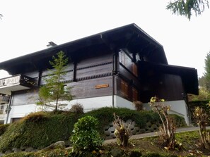Um edifício tradicional em estilo japonês, com fachada de madeira e uma placa que diz 'MAIDCHRIST'.