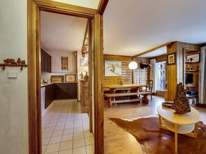 Ein rustikales Interieur mit einem Holztisch, einer Bank und einem Lederteppich.