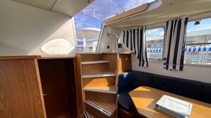 A compact cabin with a wooden interior, a small table, and a bench.
