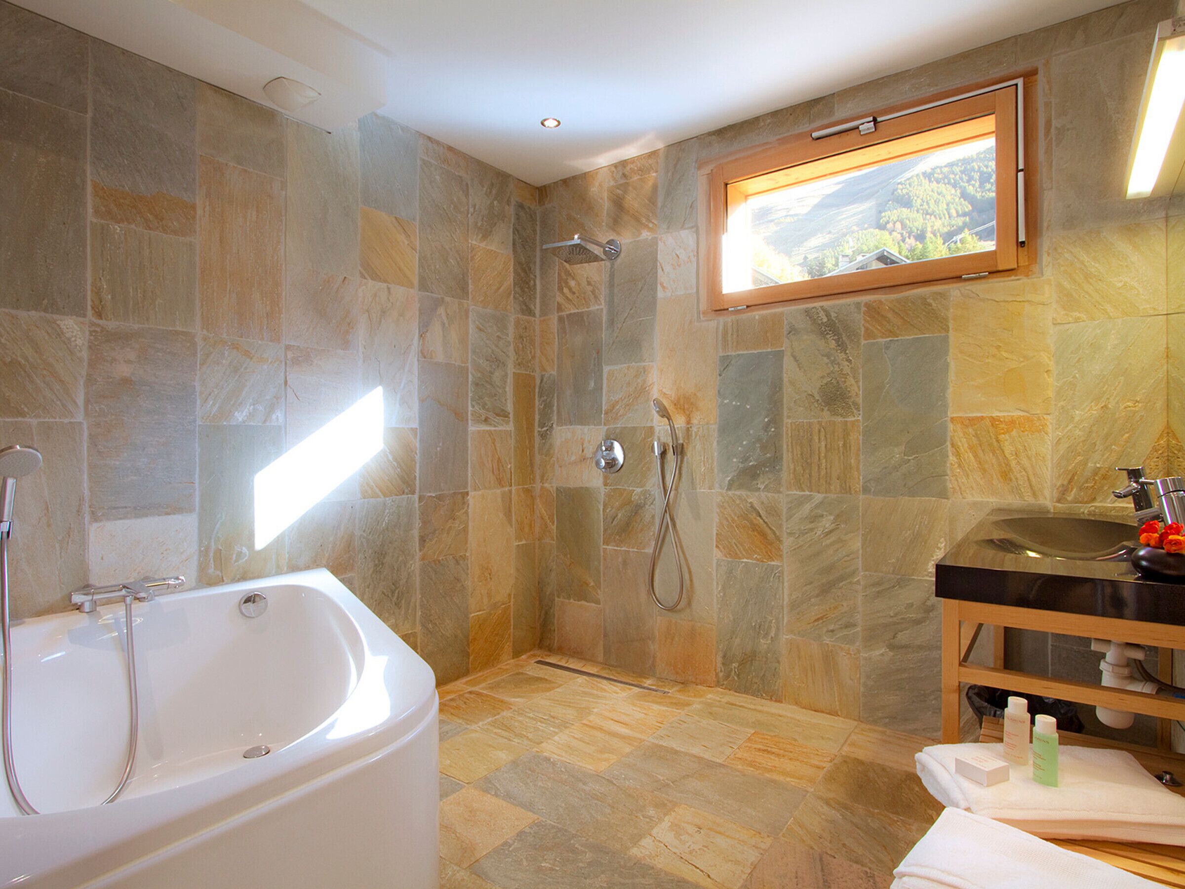 Une salle de bain avec une baignoire, une douche et un lavabo.