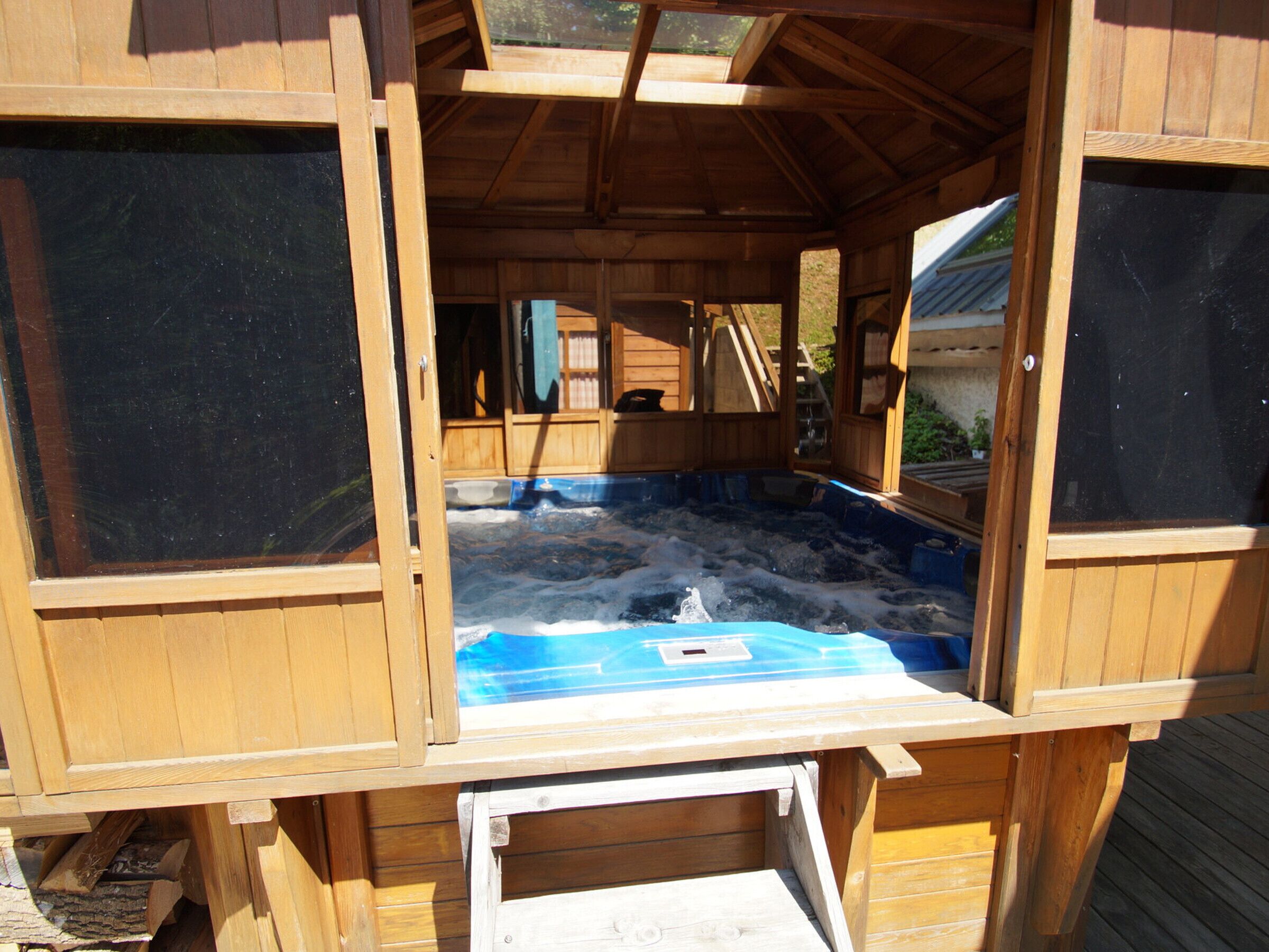 A wooden hot tub with a view of the surrounding area.
