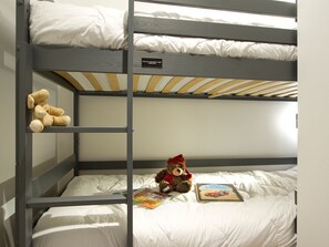 A bunk bed with a teddy bear and a book on the lower bunk. - Apartment with slope view - 5 stars (Huez)