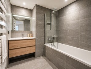 A modern bathroom with a glass-enclosed shower, a wooden vanity, and a large mirror. - Spacious, comfortable apartment - 6 guests (Huez)