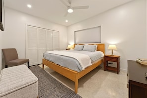 A bedroom with a bed, bedside tables, a chair, a desk, and a ceiling fan. - SEASIDE SOIREE ~ NEW LISTING! Key Haven 4 BR/3 Ba Waterfront Home! (Key West)