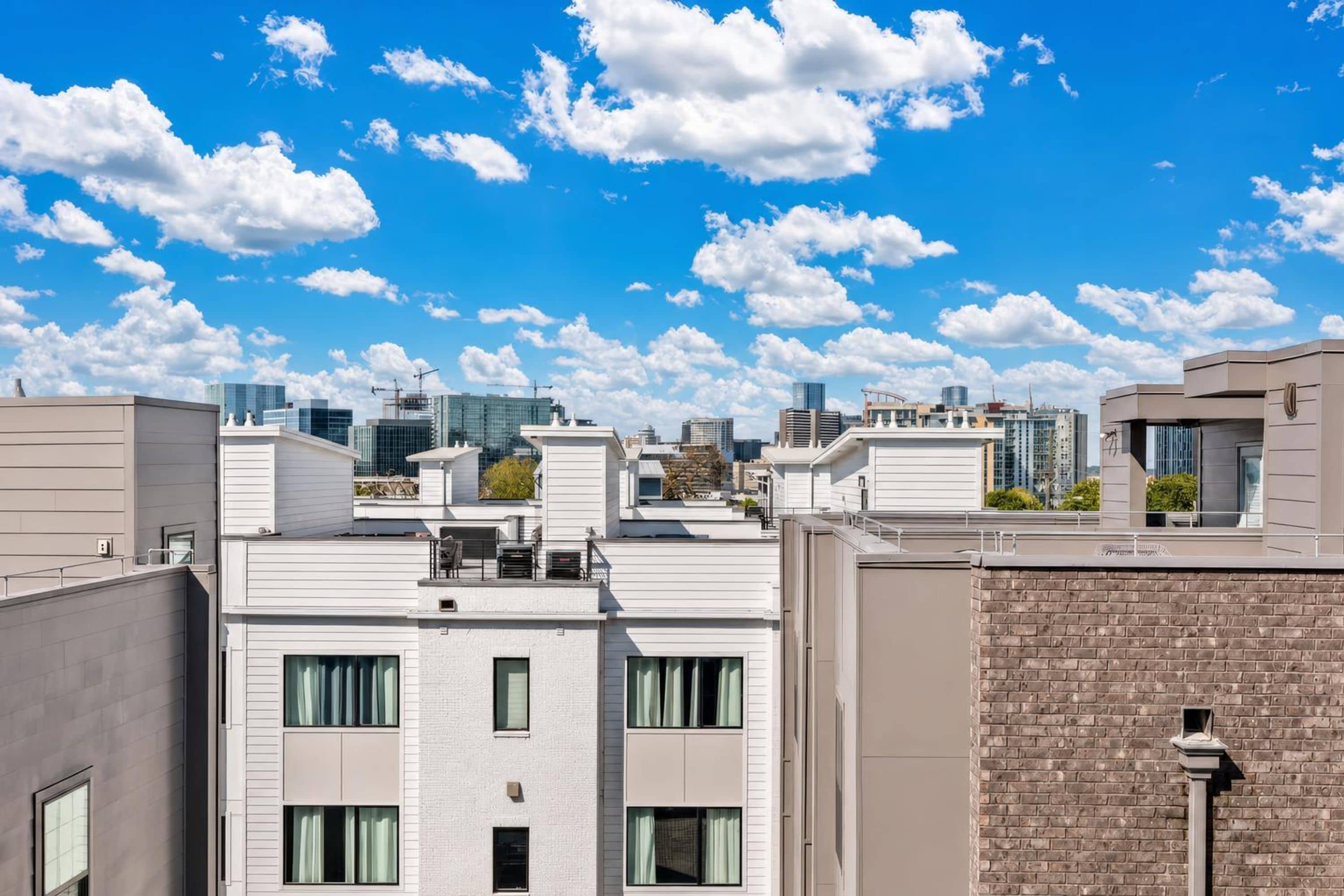 A cityscape with modern buildings and a clear sky.