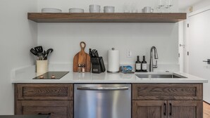 A modern kitchen with a wooden countertop, stainless steel appliances, and a built-in dishwasher. - Luxury Penthouse Studio | Ski-In/Ski-Out | Canyons Village Park City (Park City)