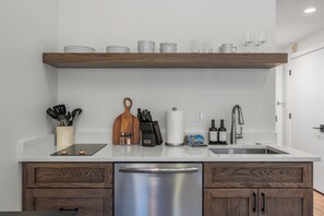 A modern kitchen with a wooden countertop, stainless steel appliances, and a built-in dishwasher. - Luxury Penthouse Studio | Ski-In/Ski-Out | Canyons Village Park City (Park City)