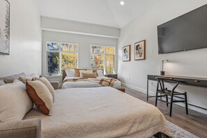 A bedroom with a large bed, a desk, and a TV. - Luxury, Renovated 2BR Penthouse | Ski-In/Ski-Out | Canyons Village Park City (Park City)