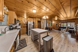 Una cocina amplia con armarios de madera, una isla central y una mesa de comedor.