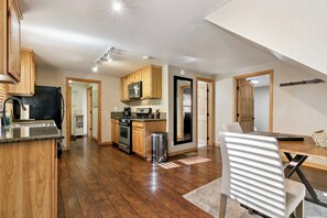 A spacious kitchen with wooden cabinets, a stainless steel refrigerator, and a microwave. - Cozy Tahoe A-Frame Cabin - Minutes to Heavenly Ski Resort, Lake & Stateline | Pet Friendly (South Lake Tahoe)