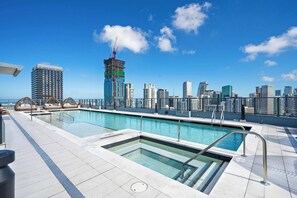 A rooftop pool with a city skyline view, including a building under construction. - 501 First | StayChic Miami | Rooftop Pool & More (Miami)