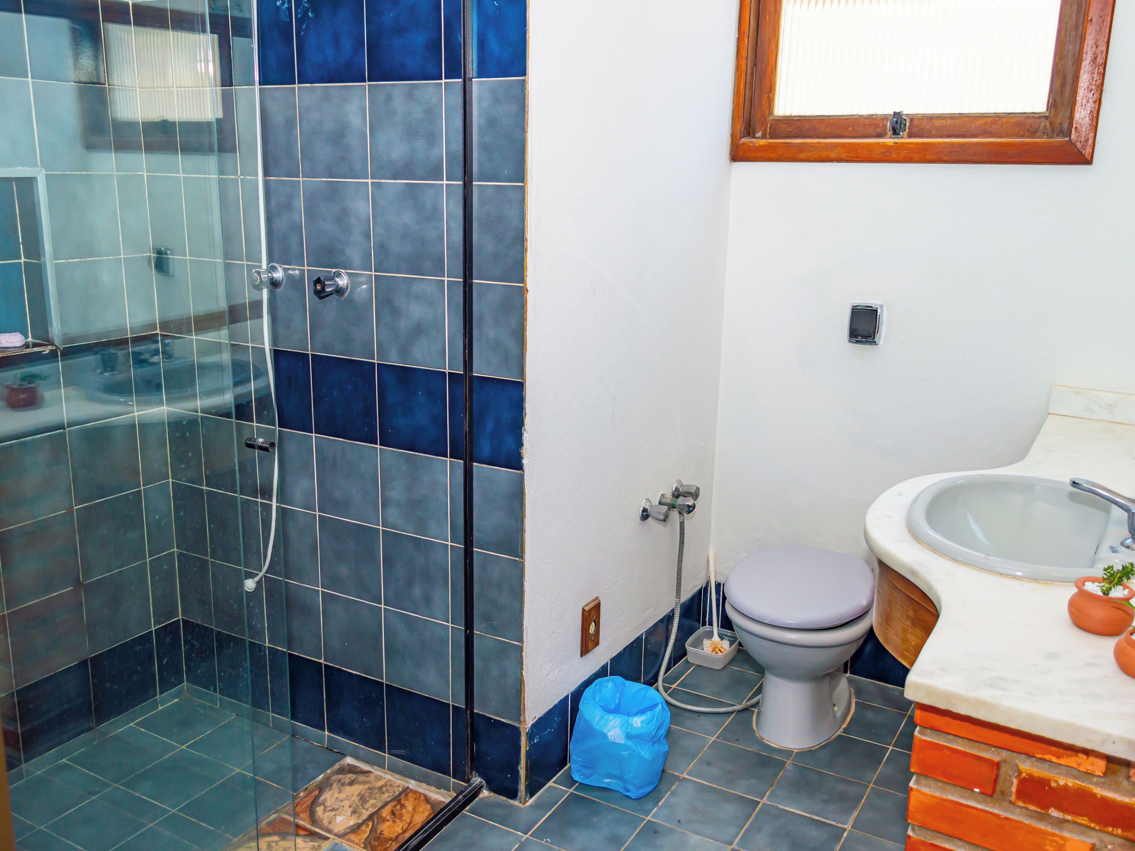 A bathroom with a shower, toilet, and sink.