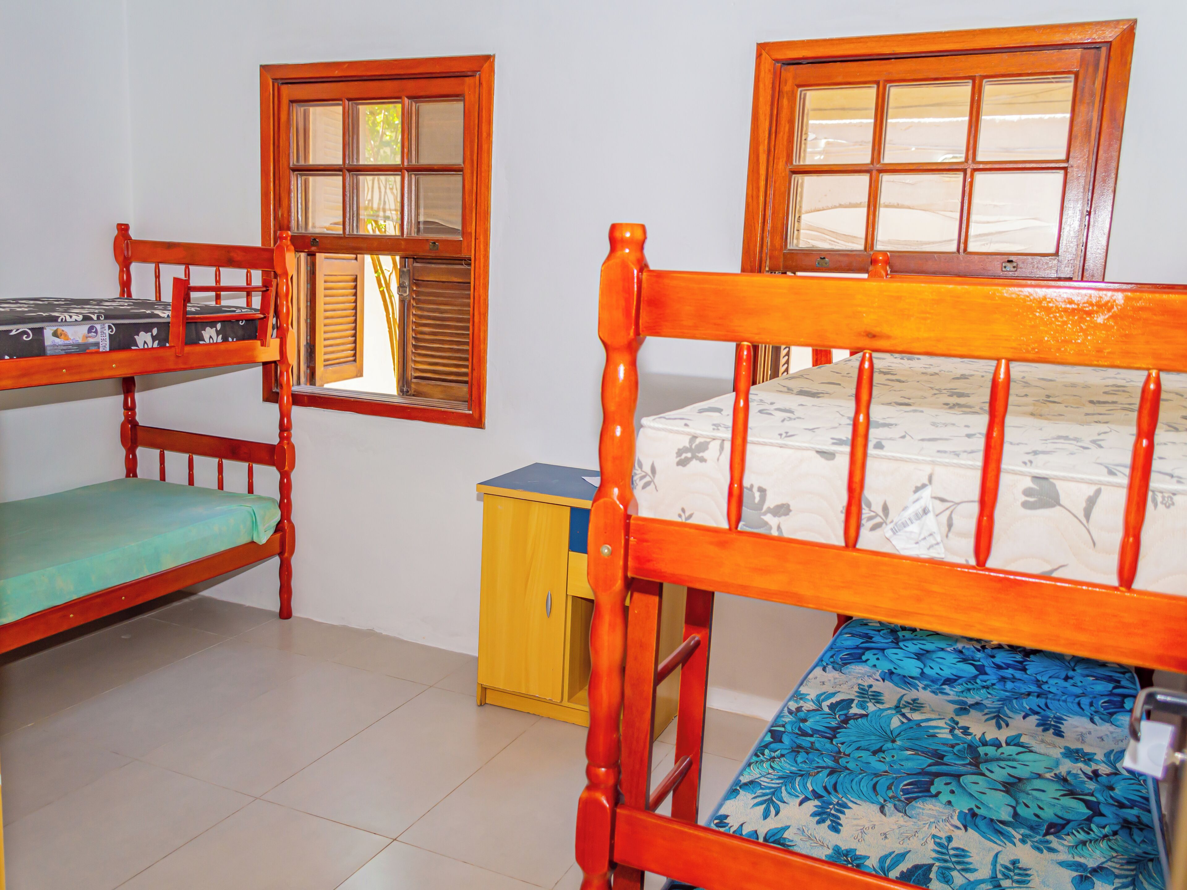 Una habitación con literas, un escritorio pequeño y una ventana.
