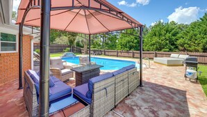 A backyard with a covered seating area, a swimming pool, and a barbecue grill. - Poolside Paradise w/ Game Room! Prattville Getaway (Prattville)