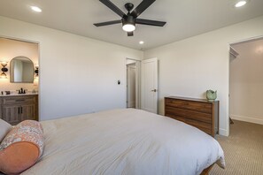 A bedroom with a bed, dresser, and a ceiling fan. - Private Home w/ Golf Course Views & Pool in Mesa! (Mesa)