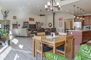 A spacious living area with a dining table, chairs, a sofa, and a television. - Exquisite Private Home Retreat Near Kenai River (Soldotna)