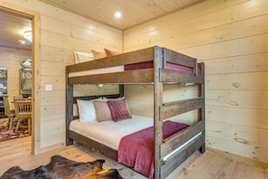 A bunk bed with a wooden frame and a headboard, a red blanket, and two pillows. - Brand-new Smokies Cabin w/ Spectacular Mtn Views (Sevierville)