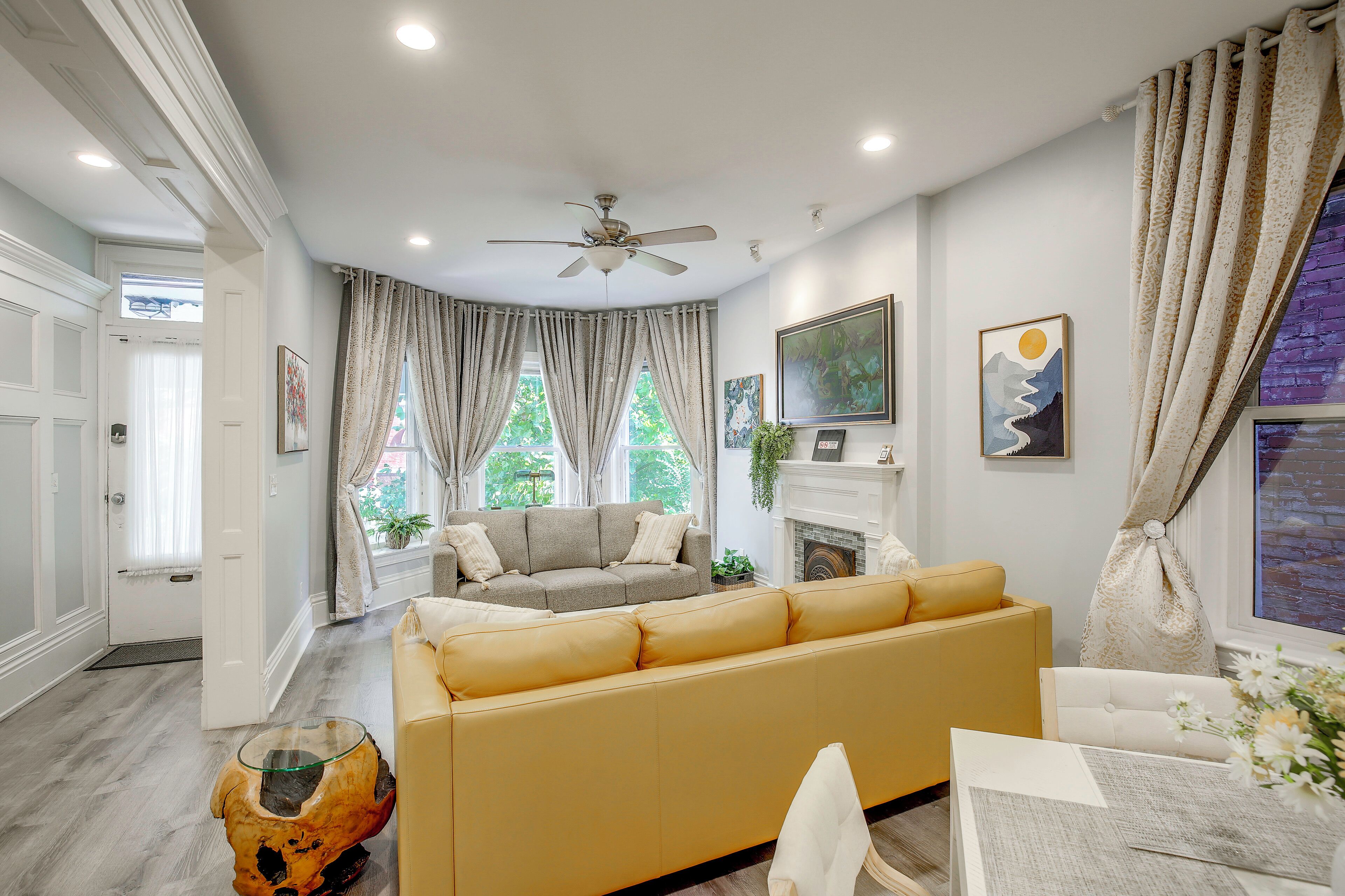 A living room with a sofa, a coffee table, and a fireplace.
