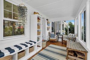 A sunlit room with a bench, a wooden table, and a chair. Shelves are filled with baskets and folded blankets. - Normandy Beach! Phenomenal Ocean Block Location (Lavallette)