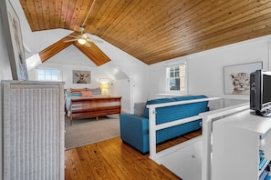 A bedroom with a sloped ceiling, a bed, a desk, and a television. - Normandy Beach! Phenomenal Ocean Block Location (Lavallette)