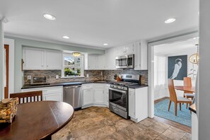 A modern kitchen with white cabinetry, a built-in microwave, and a stainless steel stove. - Normandy Beach! Phenomenal Ocean Block Location (Lavallette)