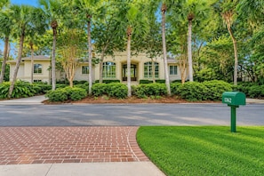 A residential building with a brick pathway leading to a green mailbox. - 9 Beach Lagoon | Lagoon Luxury with Infinity Pool | Walk to the Beach (Hilton Head Island)