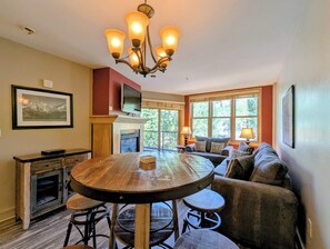 A cozy living area with a fireplace, a round dining table, and comfortable seating. - New Keystone Oasis | Walk to Slopes | Hot tubs (Keystone)
