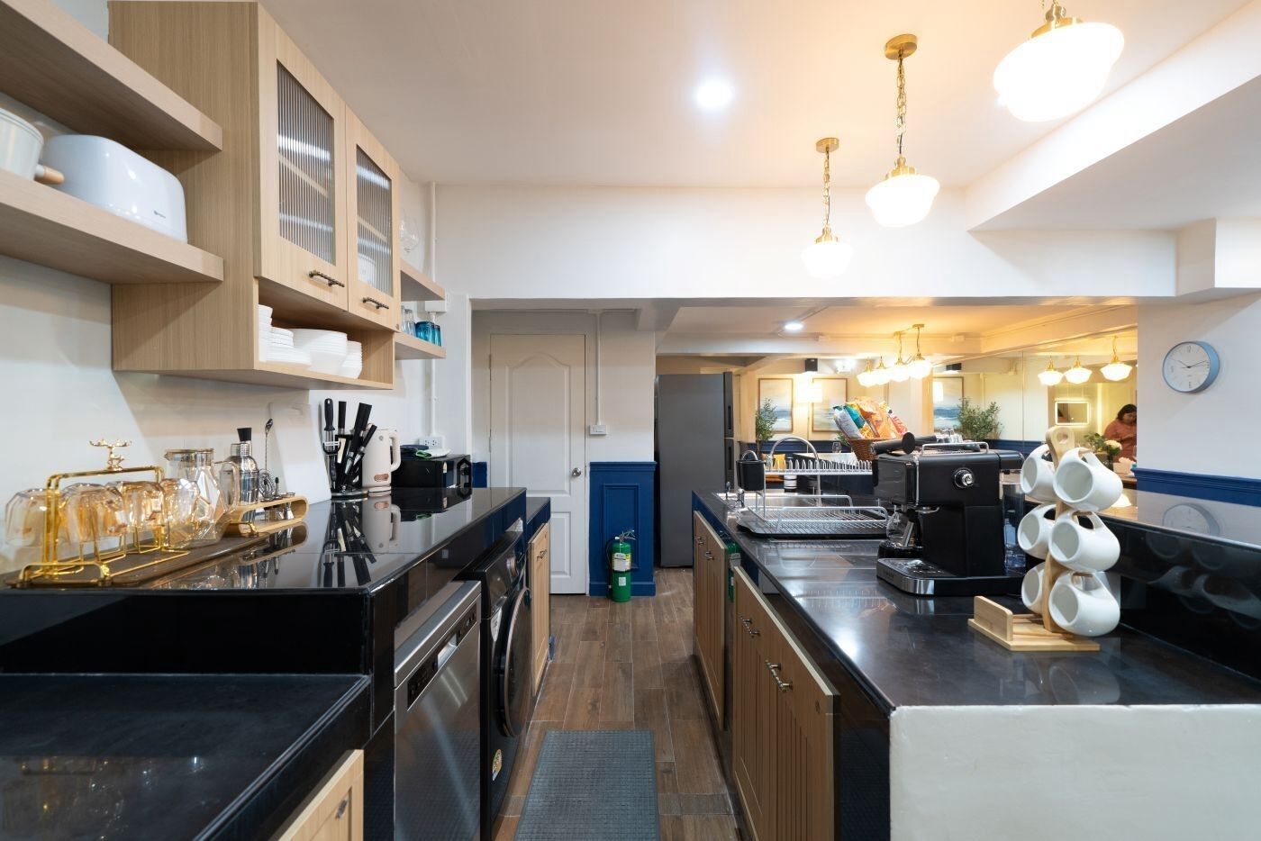 A modern kitchen with stainless steel appliances, wooden cabinets, and a central island.