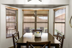 Bright casual dining nook with backyard views — a convenient spot for breakfast, coffee, or games.