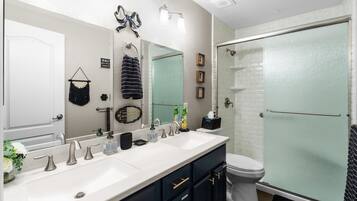 Second full bathroom with dual sinks and a shower/tub combination helps groups get ready with less waiting.