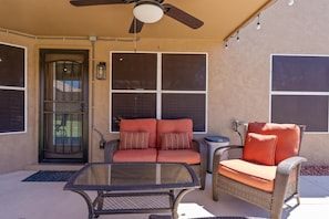 Shaded patio seating provides a comfortable place for morning coffee, conversation, or relaxing poolside.