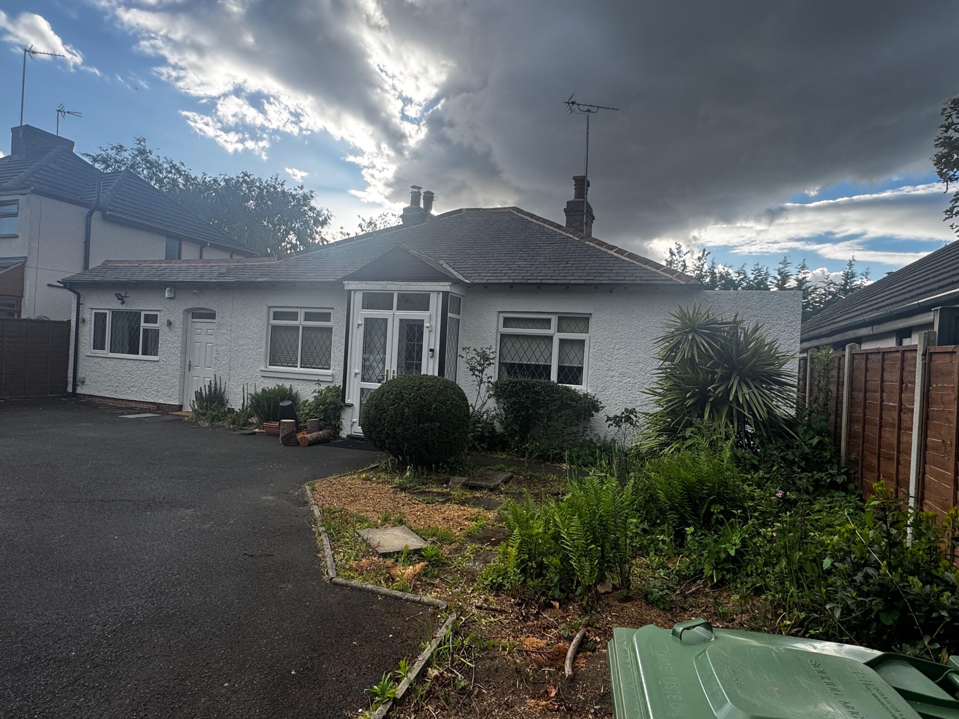 A single-story house with a white exterior, a front door, and a garage.