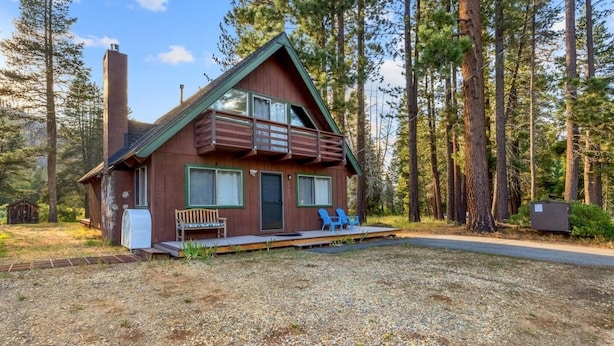 A cabin with a balcony, a bench, and a chair outside. - Tahoe River Chalet 2782b 4 Bedroom Home (South Lake Tahoe)