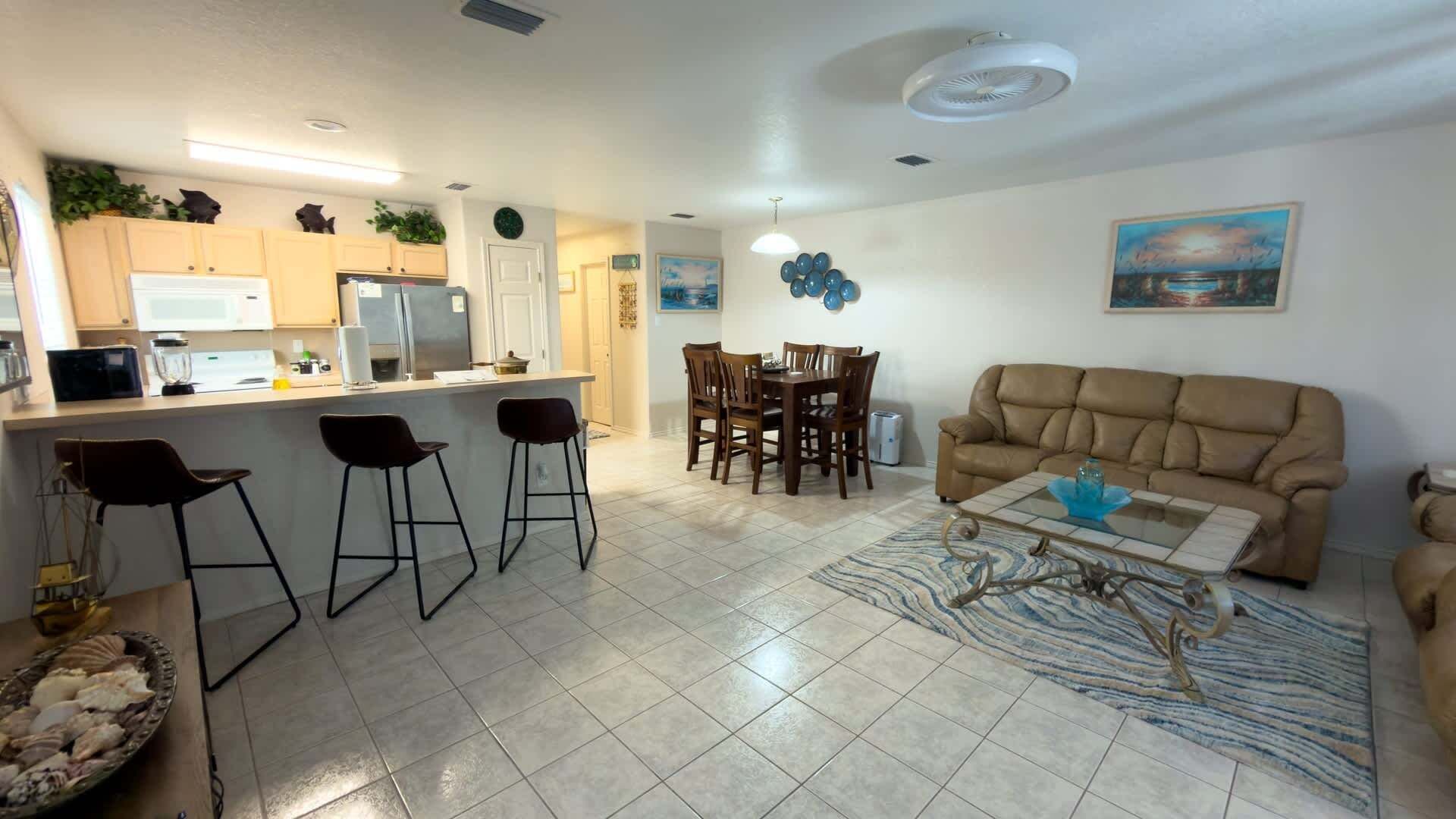A compact living space with a kitchen, dining area, and a sofa.