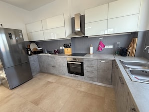 A modern kitchen with a built-in dishwasher, stainless steel appliances, and grey cabinetry. - Villa Giil - a spacious, modern, family-friendly villa with a private pool (Plaka Apokoronas)