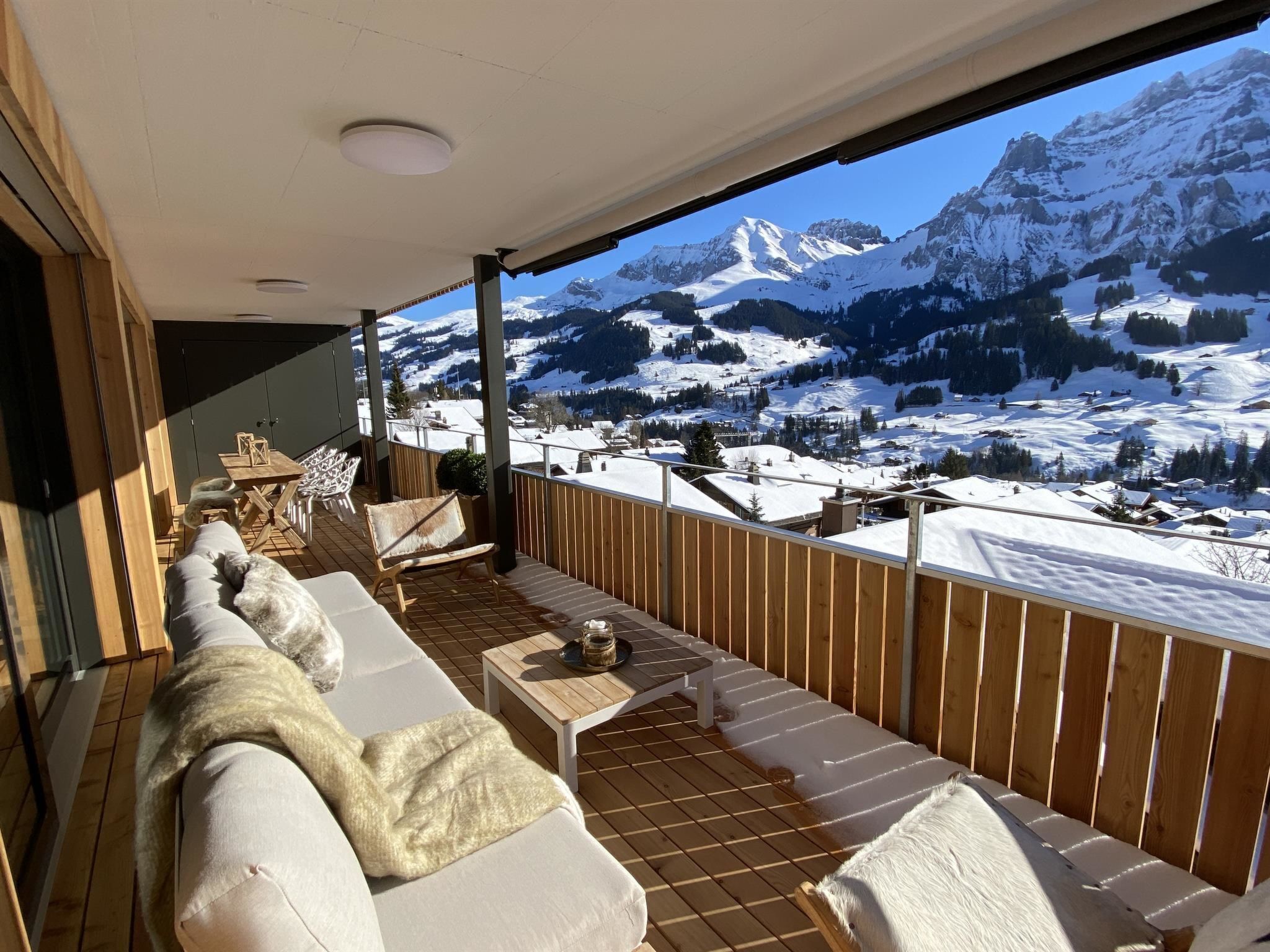 A balcony with a view of snow-covered mountains.