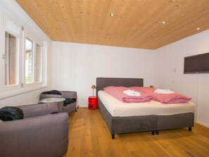 A bedroom with a bed, a sofa, a TV, and a window. - Studio Riseten Appartement/Fewo, Dusche, WC, 1 Schlafraum 1-Zimmerwohnung by Interhome (Adelboden)