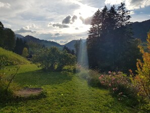 A grassy landscape with a clear sky, trees, and a mountain in the background. - Chalet Giisställi Ferienhaus, Dusche, WC Ferienhaus by Interhome (Adelboden)