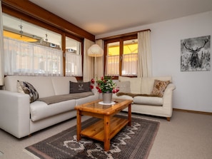 A living room with a sofa, a coffee table, and a rug. - Chalet Delphin Appartement/Fewo, Bad, WC, 1 Schlafraum 2-Zimmerwohnung by Interhome (Adelboden)