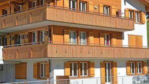 A multi-story building with wooden balconies and large windows. - Schützenrain 1. Stock Appartement/Fewo, Bad, WC, 3 Schlafräume by Interhome (Adelboden)